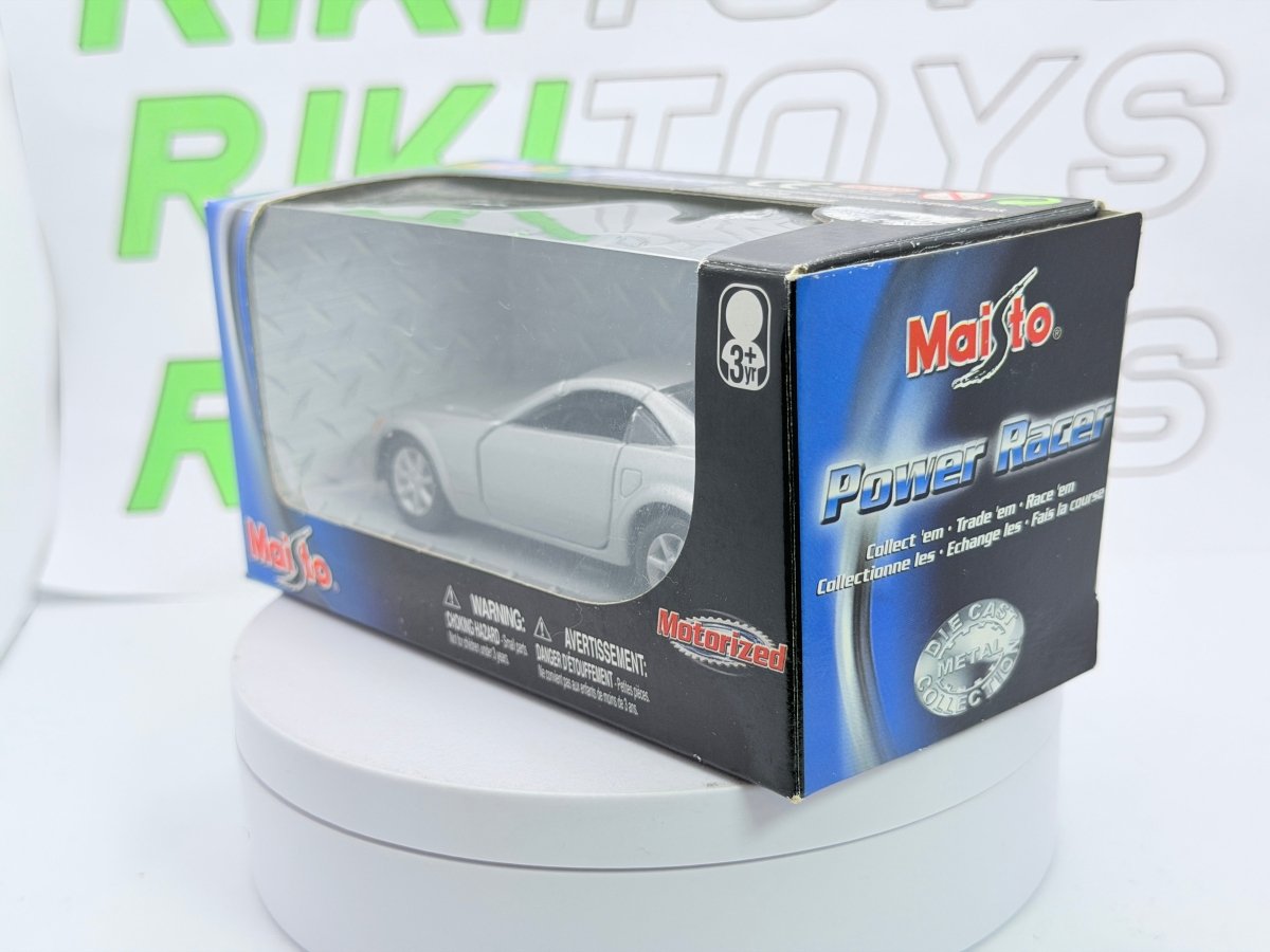 Cadillac Evoq Coupé Maisto 1/40 Argento - RikiToys - Maisto#